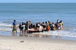 In a frenzy women storm the returning fishermen to get their share of the fish -  Morondava, Madagascar.