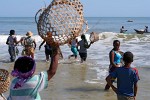 In a frenzy women storm the returning fishermen to get their share of the fish -  Morondava, Madagascar.