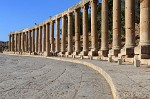 Columns around the unusual oval-shaped Forum. The Forum or plaza, in the heart of the city, links the main thouroughfare (Cardo Maximus) with the Temple of Zeus. It served as a market place and was the centre of the city's political and social life. : Jordan