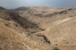 View from the Mountain of Nebo  Mount Nebo was inhabited since remote antiquity. However, its real fame derived from the bibilical event that occurred upon it as described in the Book of Deuteronommy 34: the death of Prophet Moses, who climbed this mountain at the end of his life to see the promised land. After his death he was buried in the area, although the exact location is the subject of conjecture. A Roman nun, Etheria, stumbled across the original three-apsed church on this site during a pilgrimage in AD 393. A nave was added in the 5th century, the first baptistery in 530 and the main basilica in 597, together with a large monastery. By this time Nebo had grown in an important pilgrimage site. : Jordan