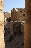 View from the Southeastern tower of Karak Castle. The very steep Glacis (artificial slope) prevented invaders from climbing up to the castle. In the background you can see the hill named Umm al-Thallaja (Mother of Snows). This hill, South of the castle, posed the greatest threat to the Castle's defences during times of siege. For this reason the Southern defences were the strongest with 6.5m-thick walls, arrow slits on all four levels and a crenellated section at the top. : Jordan