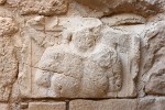 Carved relief on the East side of the Crusader Gallery (stables). The Head is missing, but the curled locks of his hair, and the ribbons attached to his head-wear can still be seen. The point of a spear projects above his right shoulder, and the head and neck of a horse are just visible above his left shoulder. A local tradition identifies this figure of Saladin (Salah al-Din), but it is much older. The carving is the funerary memorial of a Nabataean Cavalryman, fully equipped for the afterlife, and dates from the 2nd century A.D. It is one of the many pieces of ancient masonry reused in the Crusader Castle. In most cases, the Crusader masons must have used any old stone that was to hand, but in this case it may be significant that they placed the Nabataean figure so that he could be seen. Perhaps they recognized him as a fellow warrior. : Jordan