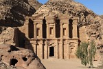 The Monastery (al-Deir)  The spectacular Monastery (locally known as Al-Deir) is hidden high up in the hills. It is similar in design to the better known Treasury but far bigger (50m wide and 45m high). Built in the 3rd century BC as a Nabataean tomb, perhaps for King Obodas I, the Monastery derives its name from the crosses carved on the inside walls, suggesting that the building was used as a church in Byzantine times. The courtyard in front of the Monastery was once surrounded by columns and was probably used for sacred ceremonies. : Jordan