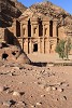 The Monastery (al-Deir)  The spectacular Monastery (locally known as Al-Deir) is hidden high up in the hills. It is similar in design to the better known Treasury but far bigger (50m wide and 45m high). Built in the 3rd century BC as a Nabataean tomb, perhaps for King Obodas I, the Monastery derives its name from the crosses carved on the inside walls, suggesting that the building was used as a church in Byzantine times. The courtyard in front of the Monastery was once surrounded by columns and was probably used for sacred ceremonies. : Jordan