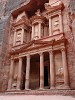 The Treasury (Al-Khazneh)  The Treasury (or locally known as Al-Khazneh) is probably the best known structure of the ancient city of Petra. It was carved out of the iron-rich sandstone rock to serve as a tomb for the Nabataean King Aretas III, probably somewhere between 100 BC and AD 200. The name Treasury is derived from a legend that bandits hid their loot in a stone urn high on the second level. Significant damage from bullets can be seen on the urn. Local lore attributes this to Bedouins, who are said to have shot at the urn in hopes of breaking it open and spilling out the "treasure" within (the decorative urn, however, is solid sandstone). Another story is that it functioned as a treasury for the Egyptian Pharaoh at the time of Moses. As with all the monuments in Petra, it's the facade that captivates, the interior is just an unadorned square hall with a smaller room in the back. The Treasury is 43m high and about 30m wide. I took this image a few minutes after sunset. : Jordan