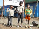 Inquisitive kids on the side of the road.