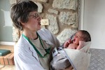 Sister Rita holds a tiny newborn.