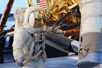 First man on the Moon, Neil Armstrong, standing next to the Apollo 11 lunar module. In the foreground Edwin "Buzz" Aldrin descends the steps of the Lunar Module ladder. Display at the Smithsonian's National Air and Space Museum.