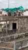 Gambling Cambodian style: The Rain-Game. These men bet when and where it is going to rain first. They bet against each other but also against other men on other roofs. They communicate their bets via mobile phones. Battambang, Cambodia. : Cambodia