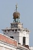 Two Atlases (presumably identical twins) holding up a bronze globe. On top of the globe stands a statue of Fortuna which acts as a weather vane by holding a garment (or perhaps a ship's rudder) to the wind. This architectural marvel crowns the tower of the Dogana di Mare (Sea Customs Post) - Venice, Italy. : Italy