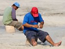 Meticulously  repairing fishingnets on Santa Clara's beach. : Panama, People