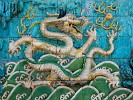 Detail of the famous Nine Dragon Screen. This wall of 270 glazed tiles is facing the Gate of Imperial Supremacy. This dragon (third from the left) has one slightly darker tile. Legend has it that the day before Emperor QianLong's inspection, this tile fell down and broke into pieces. Because there was very little time left, and everyone would be beheaded if the wall was not perfect, the tile was quickly replaced overnight by a similar wooden tile. Fortunately, the emperor did not discover the discrepancy and the lives of all the craftsmen were saved. : China