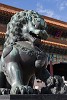 Bronze lion guarding the the forbidden city. Following tradition, the male lion guards the right side of the doorway, standing on a ball to symbolize the unity of heaven and earth, while the female lion (on the left side of the doorway) stands on a cub to represent the cycle of life. : China