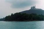 Krakatau - Sunda Strait, Indonesia. Krakatau (or Krakatao) is a volcanic island in the Sunda Strait between Java and Sumatra in Indonesia. The name is used for the island group, the main island (also called Rakata), and the volcano as a whole. It has erupted repeatedly, massively, and with disastrous consequences throughout recorded history. The best known eruption culminated in a series of massive explosions on August 26-27 1883. The 1883 eruption ejected more than 25 cubic kilometres of rock, ash, and pumice, and generated the loudest sound historically reported: the cataclysmic explosion was distinctly heard as far away as Perth in Australia approx. 1,930 miles (3,110 km), and the island of Rodrigues near Mauritius approx. 3,000 miles (5,000 km). Near Krakatau 165 villages and towns were destroyed, 132 seriously damaged and at least 36,417 people died. Many thousands of people were injured by the eruption, mostly from the tsunamis which followed the explosion. The eruption destroyed two thirds of the island of Krakatoa. Eruptions at the volcano since 1927 have built a new island in the same location, called Anak Krakatau (child of Krakatoa).