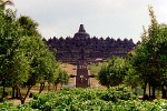 Borubudur - Central Java, Indonesia. Borobudur is a ninth century Mahayana Buddhist monument. The monument comprises six square platforms topped by three circular platforms, and is decorated with 2,672 relief panels and 504 Buddha statues.A main dome is located at the center of the top platform, and is surrounded by seventy-two Buddha statues seated inside perforated stupa. The monument is both a shrine to the Lord Buddha and a place for Buddhist pilgrimage. The journey for pilgrims begins at the base of the monument and follows a path circumambulating the monument while ascending to the top through the three levels of Buddhist cosmology, namely, Kamadhatu (the world of desire); Rupadhatu (the world of forms); and Arupadhatu (the world of formless). During the journey, the monument guides the pilgrims through a system of stairways and corridors with 1,460 narrative relief panels on the wall and the balustrades. Evidence suggests Borobudur was abandoned following the fourteenth century decline of Buddhist and Hindu kingdoms in Java, and the Javanese conversion to Islam. It was rediscovered in 1814 by Sir Thomas Raffles, the British ruler of Java. Borobudur has since been preserved through several restorations. The largest restoration project was undertaken between 1975 and 1982 by the Indonesian government and UNESCO, following which the monument was listed as a UNESCO World Heritage Site. Borobudur is still used for pilgrimage, where once a year Buddhists in Indonesia celebrate Vesak at the monument.