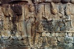 Carved relief at Borubudur - Central Java, Indonesia. Borobudur contains approximately 2,670 individual bas reliefs (1,460 narrative and 1,212 decorative panels), which cover the façades and balustrades. The total relief surface is 2,500 square meters (26,909.8 sq ft) and they are distributed at the hidden foot (Kamadhatu) and the five square platforms (Rupadhatu). The narrative panels, which tell the story of Sudhana and Manohara, are grouped into 11 series encircled the monument with the total length of 3,000 meters (9,843 ft). The hidden foot contains the first series with 160 narrative panels and the remaining 10 series are distributed throughout walls and balustrades in four galleries starting from the eastern entrance stairway to the left. Narrative panels on the wall read from right to left, while on the balustrade read from left to right. This conforms with pradaksina, the ritual of circumambulation performed by pilgrims who move in a clockwise direction while keeping the sanctuary to their right.The hidden foot depicts the story of the karma law. The walls of the first gallery have two superimposed series of reliefs; each consists of 120 panels. The upper part depicts the biography of Buddha, while the lower part of the wall and also balustrades in the first and the second galleries tell the story of Buddha's former lives. The remaining panels are devoted to Sudhana's further wandering about his search; terminated by his attainment of the Perfect Wisdom.