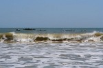 Fishermen awaiting for the right surf to return to shore after spending the night at sea fishing - Morondava, Madagascar.