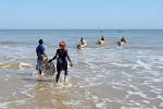 In a frenzy women storm the returning fishermen to get their share of the fish -  Morondava, Madagascar.